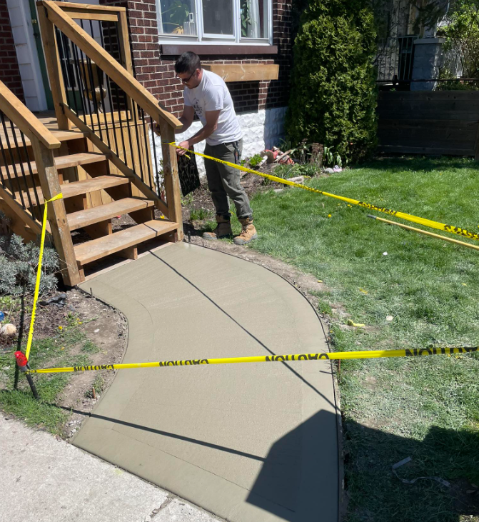 Concrete worker finishing a fresh pour